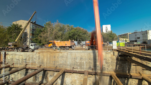 Huge ditch pit at the construction site of the underground metro station line timelapse. photo