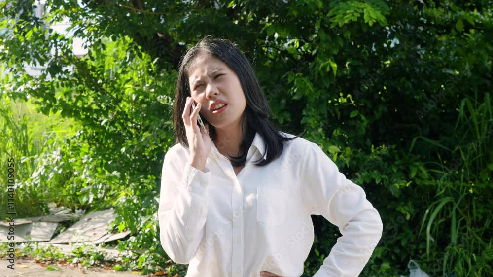 Portrait, Asian woman has street wisdom, pressed cell phone call landlord in concern, woman calling auto mechanic, auto insurance come scene, woman expression was tense there is great concern. Portrait, Asian woman has street wisdom, pressed cell phone call landlord in concern, woman calling auto mechanic, auto insurance come scene, woman expression was tense there is great concern.