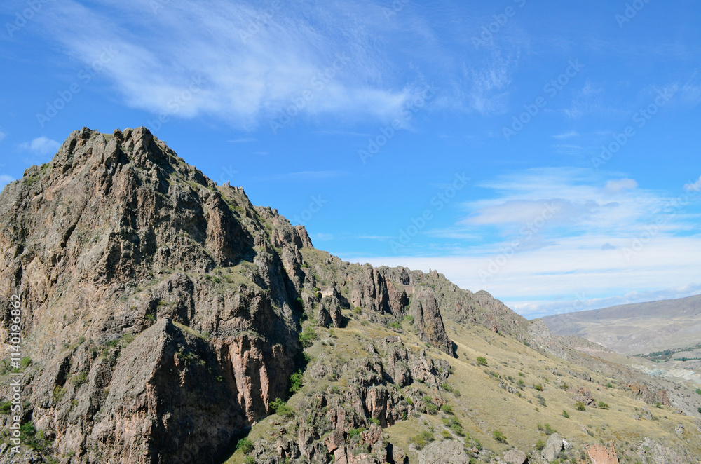 Fototapeta premium Rugged Mountain Landscape with Steep Slopes and Rocky Terrain
