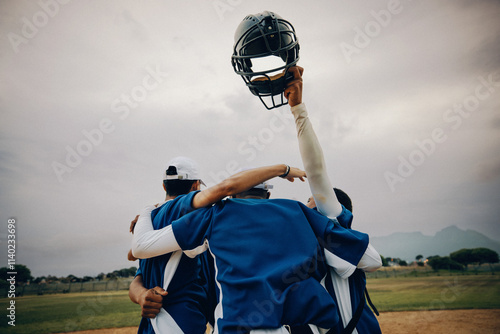 Blue baseball team celebrating victory with players raising helmet in the air on a field photo