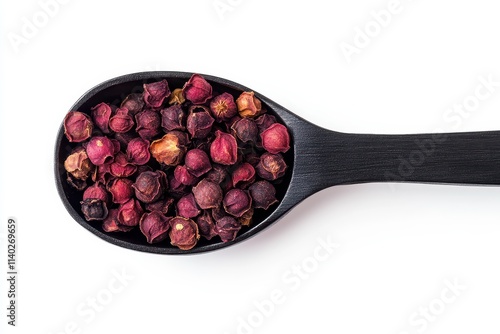 Bird s eye view of dried magnolia seeds in teaspoon cutout on white backdrop photo