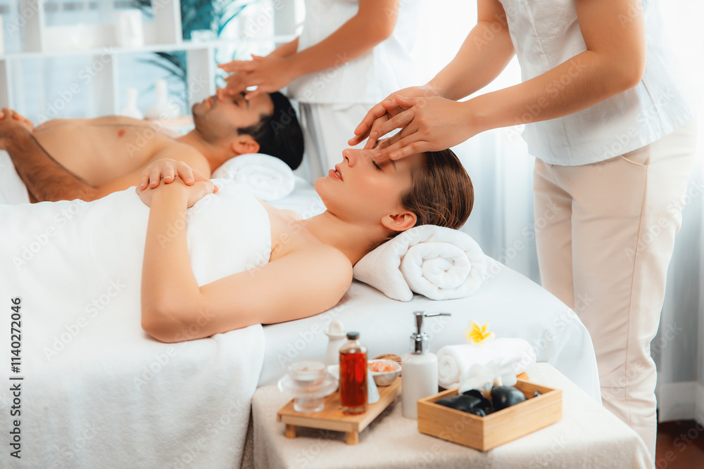 Obraz premium Caucasian couple enjoying relaxing anti-stress head massage and pampering facial beauty skin recreation leisure in dayspa modern light ambient at luxury resort or hotel spa salon. Quiescent