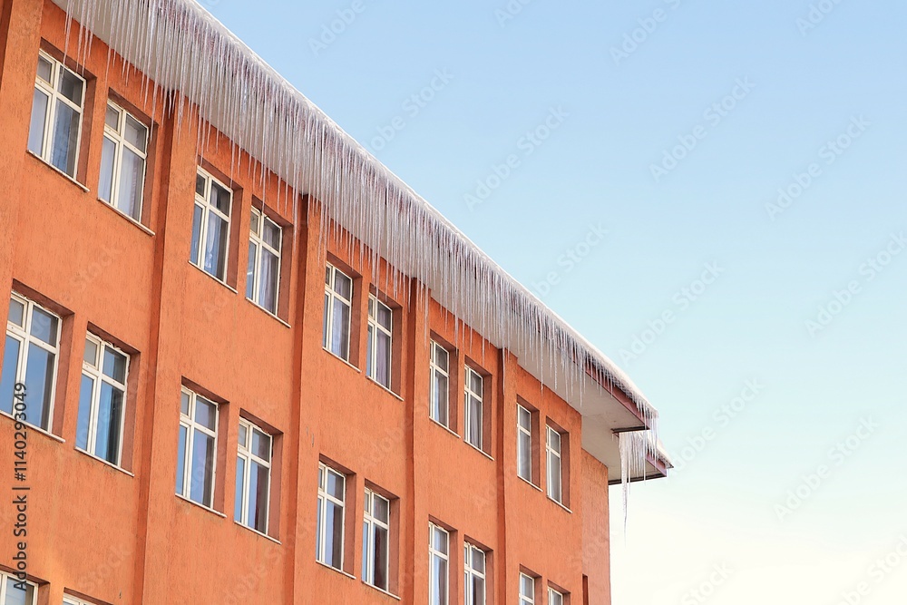 © Dr.MYM - Giant icicles hang from the edges of a building's roof during freezing winter in Erzurum, Turkey, where temperatures can drop to -50°C. A stunning natural phenomenon in extreme cold weather. © Dr.MYM - Giant icicles hang from the edges of a building's roof during freezing winter in Erzurum, Turkey, where temperatures can drop to -50°C. A stunning natural phenomenon in extreme cold weather.