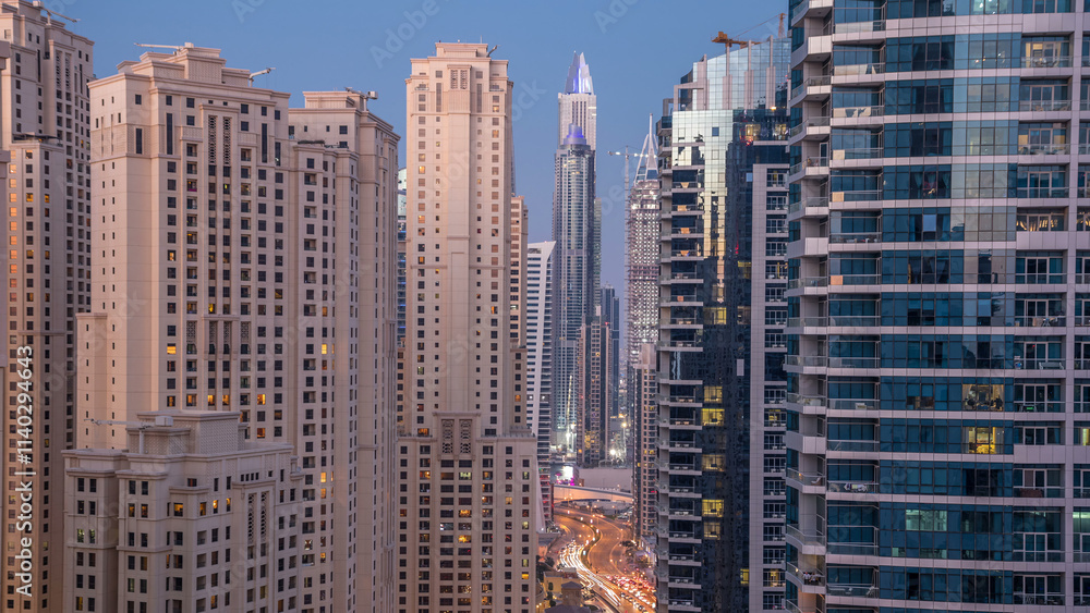 Obraz premium Evening illumination of Dubai Marina day to night aerial timelapse, UAE.