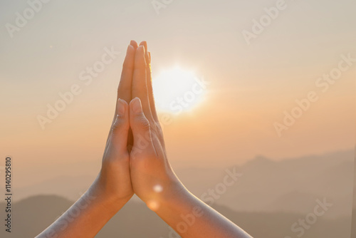 Closeup human hands place together like praying worship at sunset.worship god with christian concept religion. photo