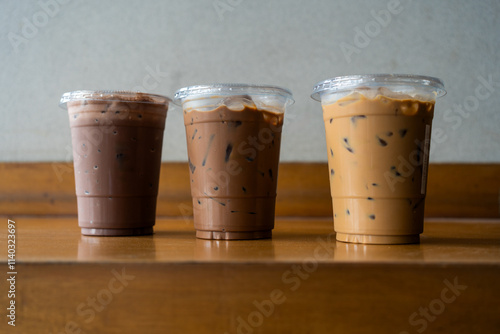 Close up view of iced mocha, Iced espresso and iced chocolate in a plastic glass at cafe restaurant. Coffee shop, cafe leisure lifestyle