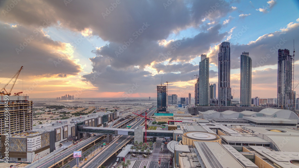 Obraz premium Sunrise aerial view of Financial center road morning timelapse with under construction building