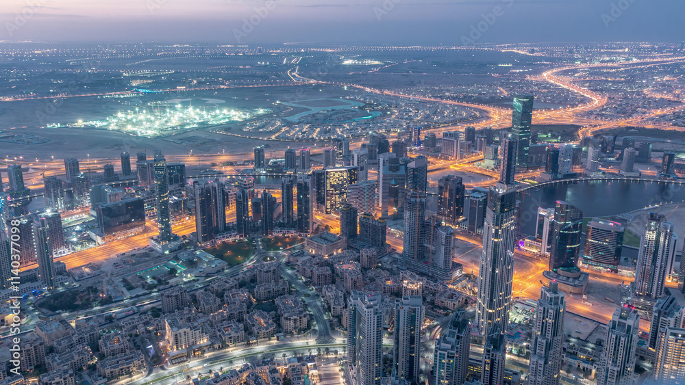 Obraz premium Downtown of Dubai night to day timelapse before sunrise. Aerial view with towers and skyscrapers