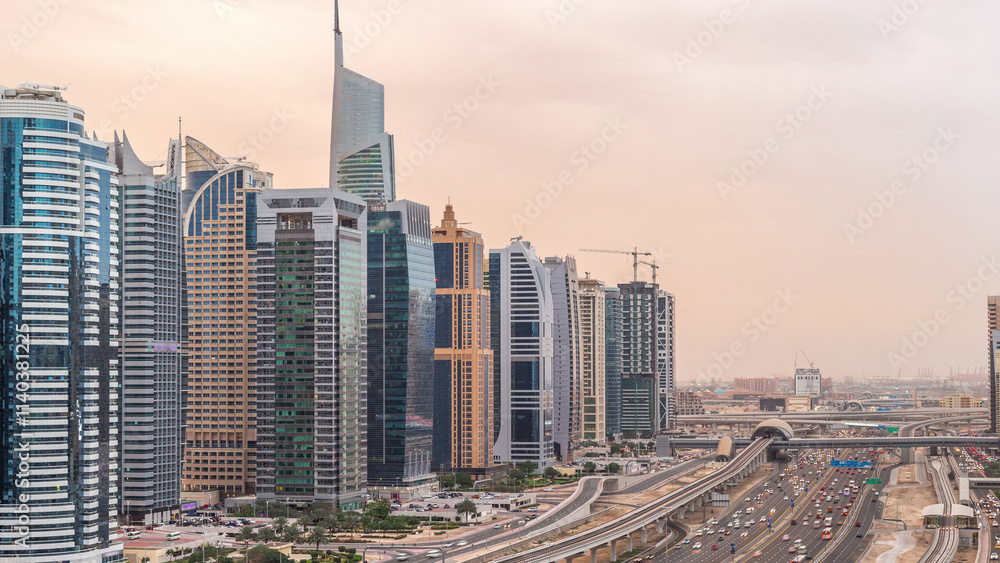 Fototapeta premium Aerial top view to Sheikh Zayed road near Dubai Marina and JLT day to night timelapse, Dubai.