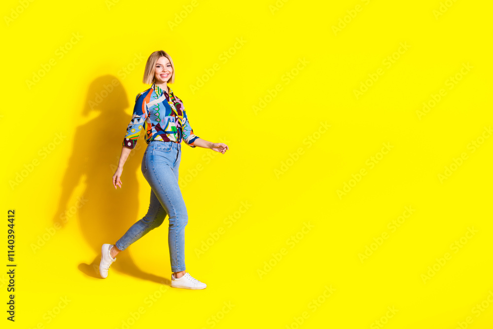 Full body photo of attractive young woman walking black friday dressed stylish colorful clothes isolated on yellow color background Full body photo of attractive young woman walking black friday dressed stylish colorful clothes isolated on yellow color background