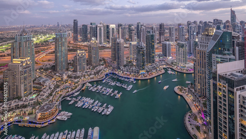 Dubai Marina skyscrapers and jumeirah lake towers view from the top aerial day to night timelapse in the United Arab Emirates. photo