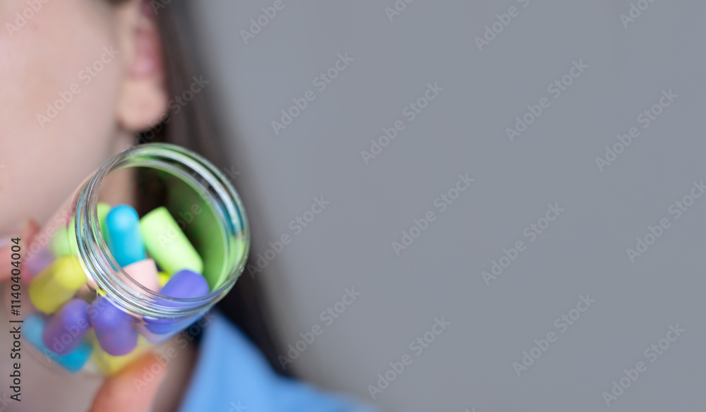 Woman holding a canister with many earplugs, gadgets for convenience – how earplugs help in daily life, at work or home. Woman holding a canister with many earplugs, gadgets for convenience – how earplugs help in daily life, at work or home.