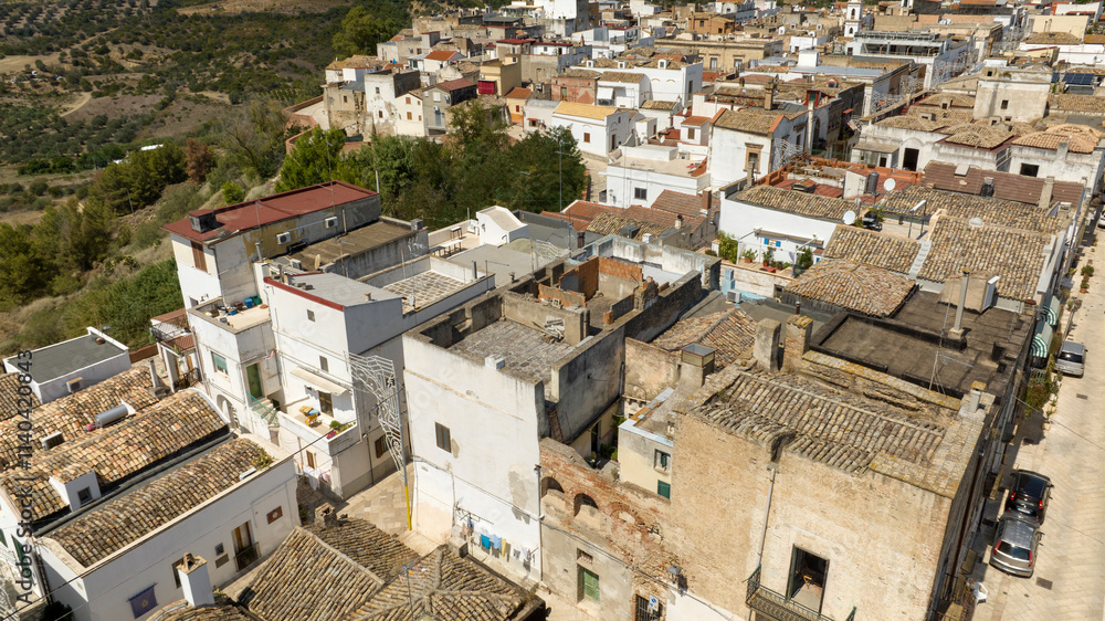 Aerial view of houses, apartments and buildings located in the historic center of the town of Bernalda, in the province of Matera, Basilicata, Italy. It is a traditional Italian village. Aerial view of houses, apartments and buildings located in the historic center of the town of Bernalda, in the province of Matera, Basilicata, Italy. It is a traditional Italian village.