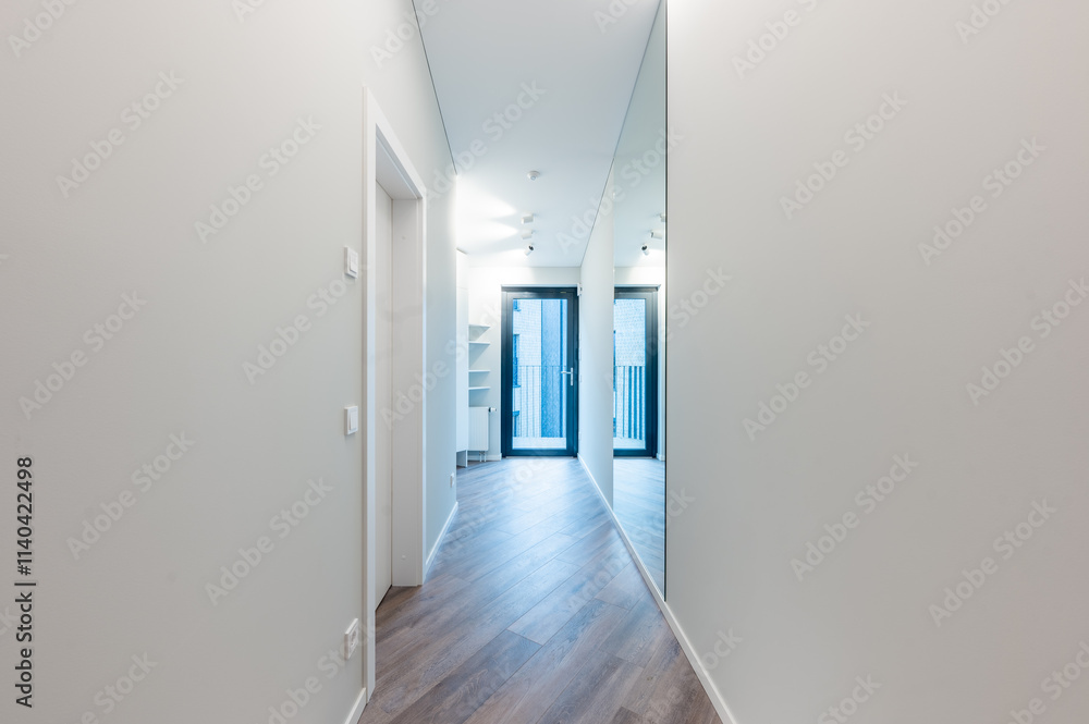 Fototapeta premium Modern Home Hallway With Wooden Floor and Mirror Featuring Contemporary Lighting