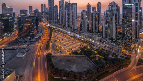 Photography Modern residential and office complex with many towers aerial day to night timelapse at Business Bay, Dubai, UAE