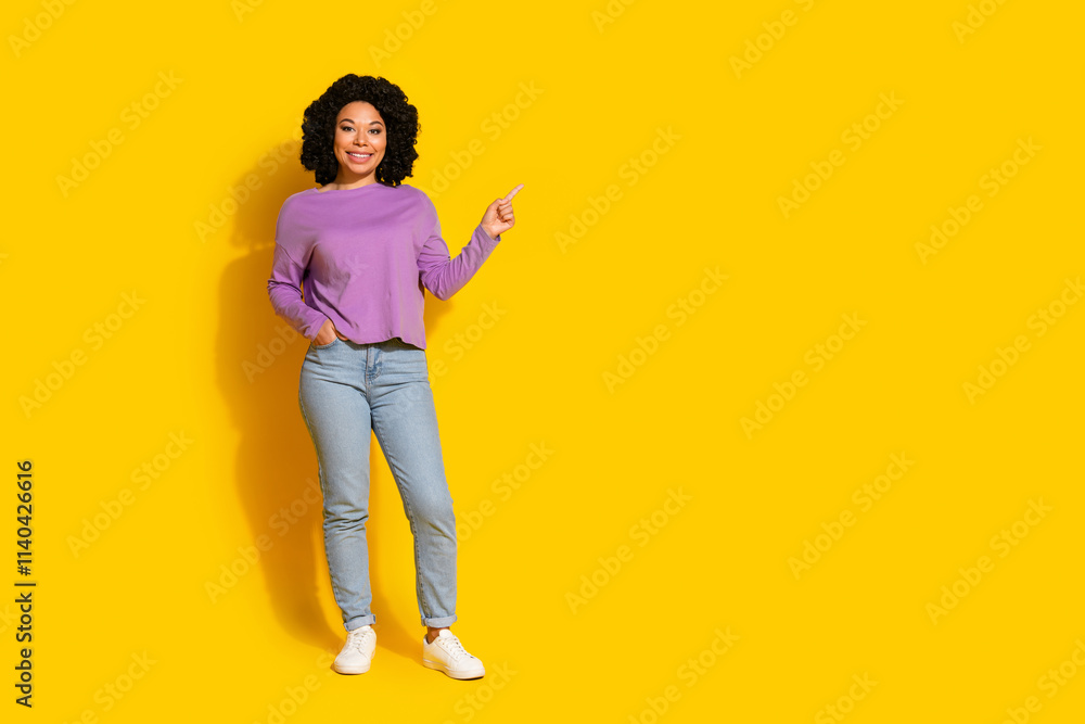 Full size photo of nice young woman direct finger empty space isolated on yellow color background Full size photo of nice young woman direct finger empty space isolated on yellow color background