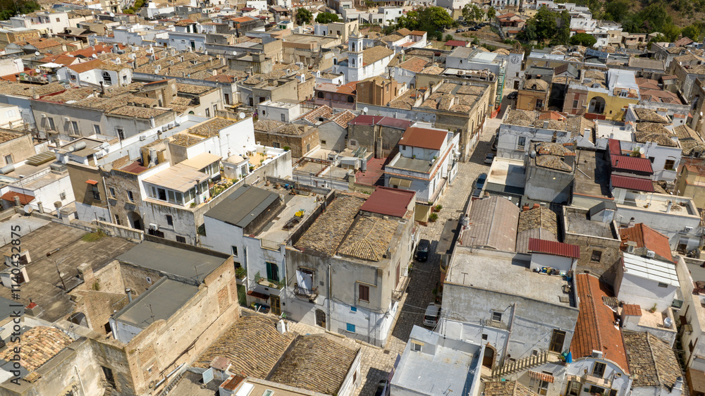 Aerial view of houses, apartments and buildings located in the historic center of the town of Bernalda, in the province of Matera, Basilicata, Italy. It is a traditional Italian village. Aerial view of houses, apartments and buildings located in the historic center of the town of Bernalda, in the province of Matera, Basilicata, Italy. It is a traditional Italian village.