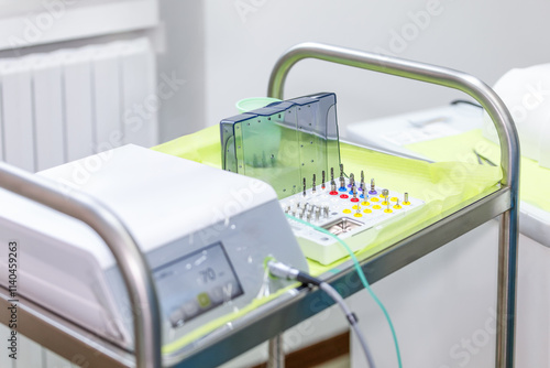 Dental implant surgical kit with drills and tools organized on a sterile tray in a clinical setting, ready for a dental procedure photo