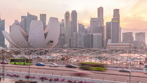 Aerial view over Helix Bridge and Bayfront Avenue with traffic day to night timelapse at Marina Bay, Singapore photo