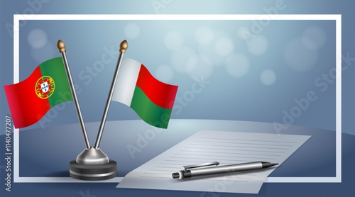 Portugal and Madagascar National flags on small table with bokeh background, cooperative relationship