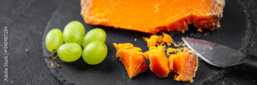 Aged cheese Mimolette or cheddar fresh tasty food dish delicious gourmet food background on the table rustic food top view copy space