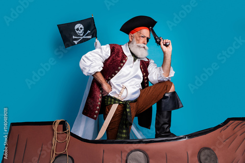 Photo of pensive thoughtful pirate wearing traditional costume swimming in boat isolated on blue color background photo