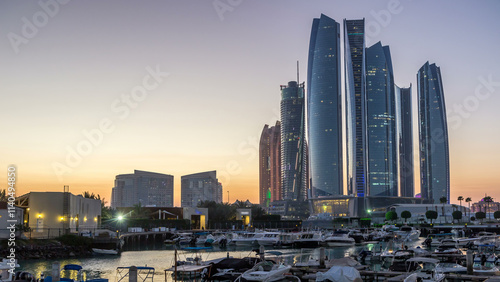 Al Bateen marina Abu Dhabi day to night timelapse with modern skyscrapers on background photo