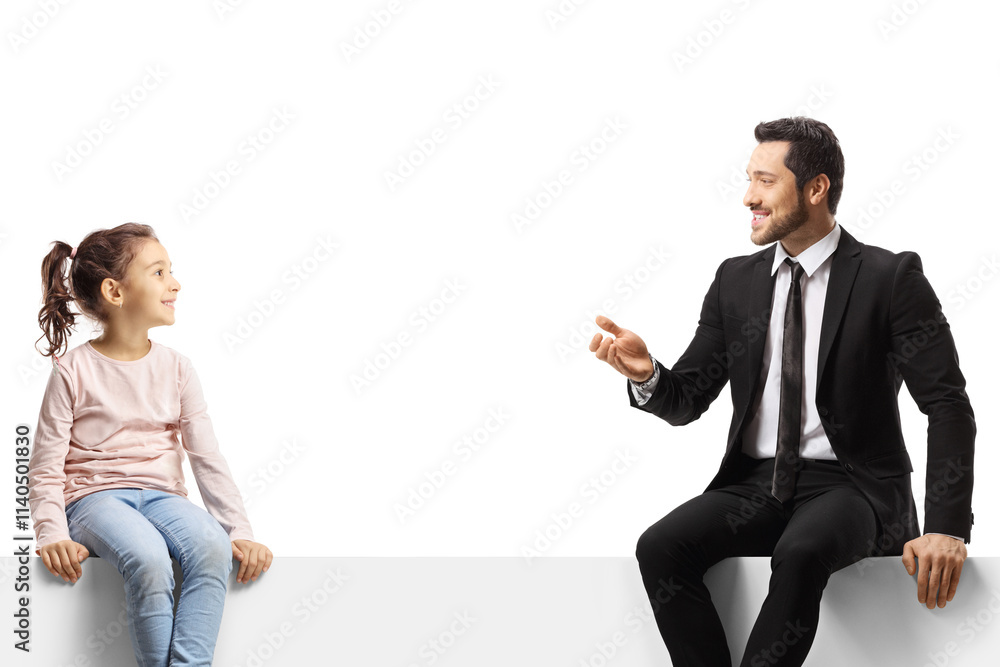 Businessman sitting on a panel and talking to a little girl Businessman sitting on a panel and talking to a little girl