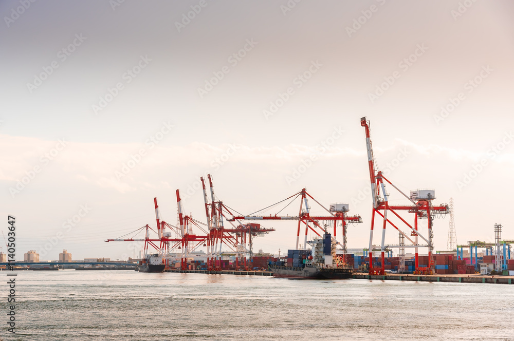 Container port and container crane at Industrial port for cargo container ship Osaka Japan. Business logistic transportation concept. Container port and container crane at Industrial port for cargo container ship Osaka Japan. Business logistic transportation concept.