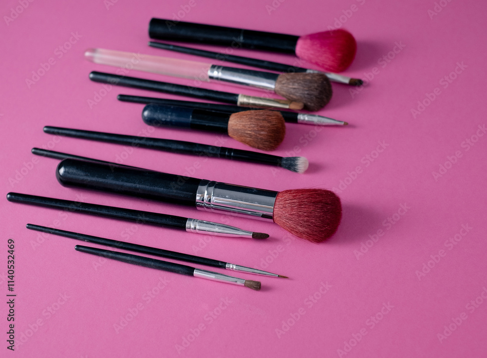 Set of makeup brushes on pastel pink background Set of makeup brushes on pastel pink background