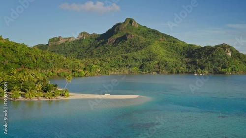 Aerial drone capture stunning Maupiti island, French Polynesia: white sand beach, turquoise waters, lush green mountain landscape. Wild travel destination, remote nature paradise, exotic summer travel