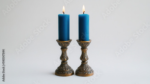 Two ornate bronze candlesticks with matte royal blue candles, detailed carvings on the candlestick body, white background enhancing the contrast, minimalistic yet elegant presentation, polished fine c