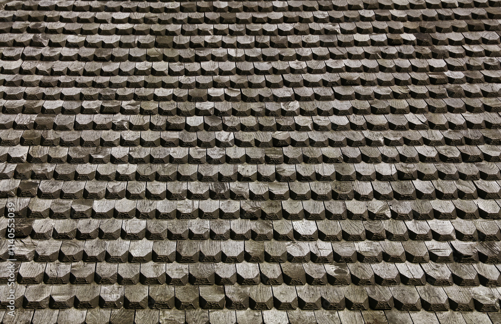 Traditional wooden roof shingles creating a textured surface Traditional wooden roof shingles creating a textured surface