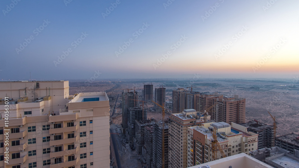 Cityscape of Ajman from rooftop before sunrise night to day timelapse. United Arab Emirates. Cityscape of Ajman from rooftop before sunrise night to day timelapse. United Arab Emirates.