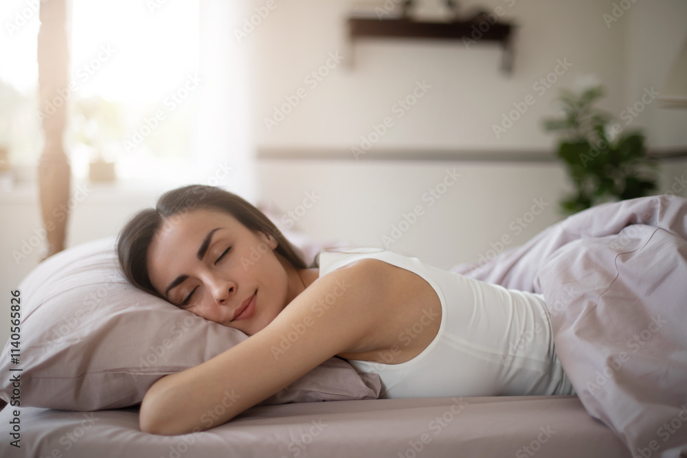 A young woman sleeps peacefully on a soft bed, her head resting on pillow wrapped in cozy lavender sheets.The bright calm bedroom exudes serenity and relaxation. Perfect for sleep or wellness themes A young woman sleeps peacefully on a soft bed, her head resting on pillow wrapped in cozy lavender sheets.The bright calm bedroom exudes serenity and relaxation. Perfect for sleep or wellness themes