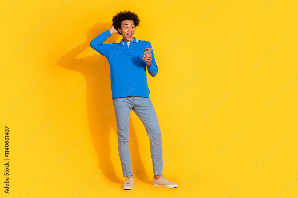 Fototapeta premium Full size photo of nice young man use smart phone empty space isolated on yellow color background