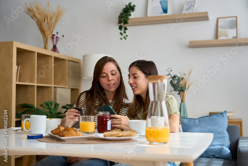 Lesbian couple enjoys breakfast at home together photo