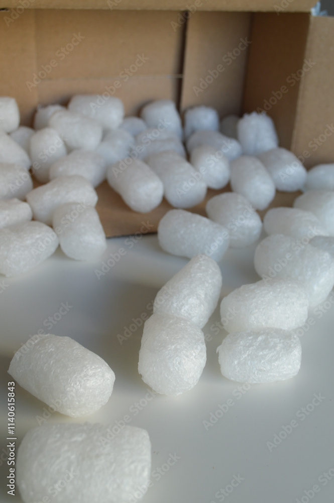 Cardboard Box with Protective Packaging for Shipping Goods. A cardboard shipping box filled with protective packaging materials, including eco-friendly paper padding and biodegradable packing peanuts. Cardboard Box with Protective Packaging for Shipping Goods. A cardboard shipping box filled with protective packaging materials, including eco-friendly paper padding and biodegradable packing peanuts.