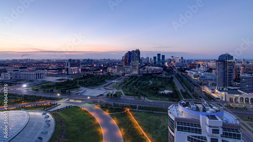 Aerial view over the city center and central business district night to day timelapse, Kazakhstan, Astana photo