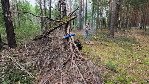 Wallpaper Mural A tourist made a stop in the forest and is building a shelter Torontodigital.ca