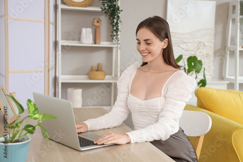Beautiful young woman using...