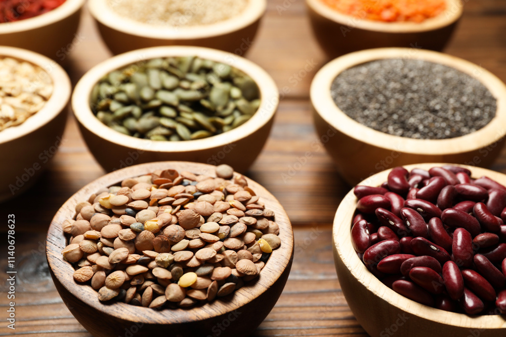 Different superfood products in bowls on wooden table, closeup Different superfood products in bowls on wooden table, closeup