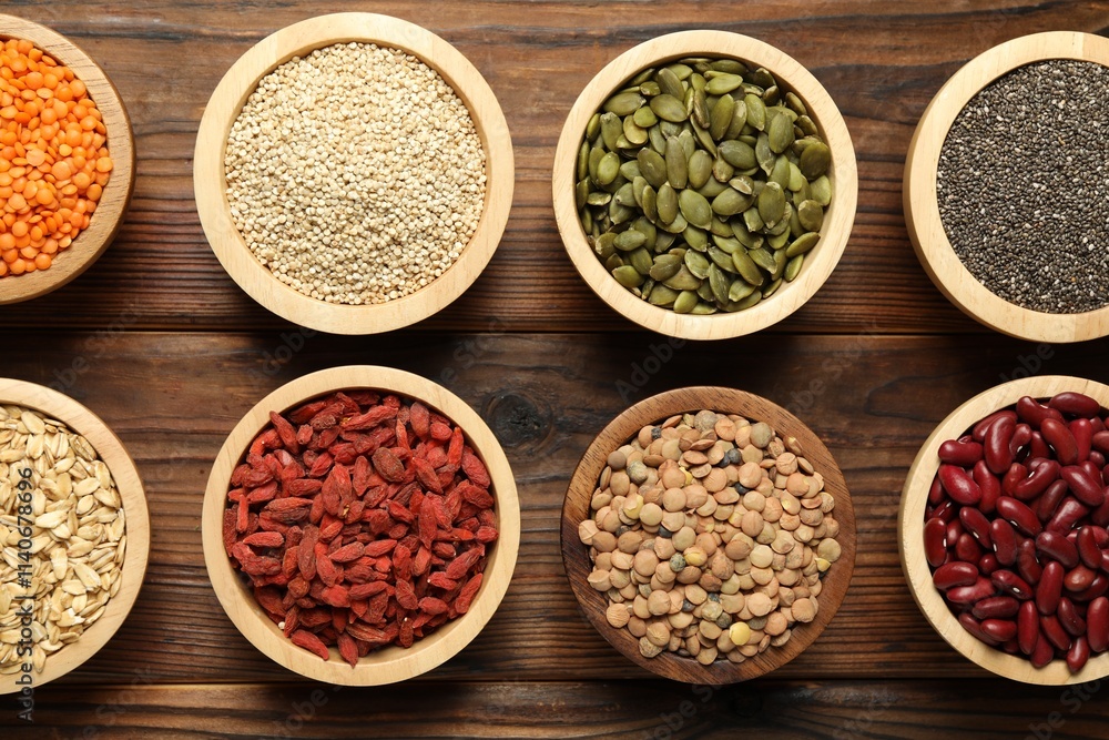 Different superfood products in bowls on wooden table, flat lay Different superfood products in bowls on wooden table, flat lay
