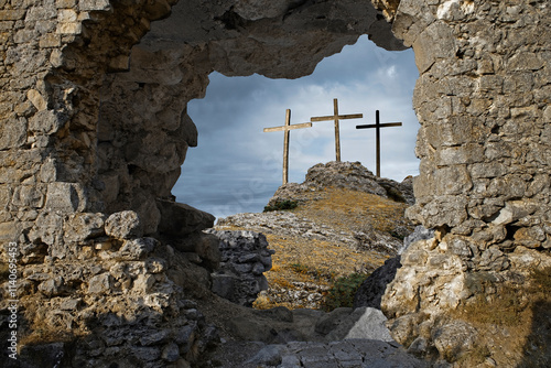 Fotografie Three wooden crosses on hill against sky