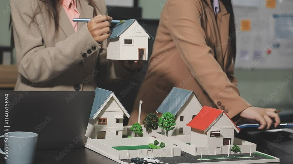 House model with agent and customer discussing calculate for price contract to buy, get insurance or loan real estate or property. House model with agent and customer discussing calculate for price contract to buy, get insurance or loan real estate or property.