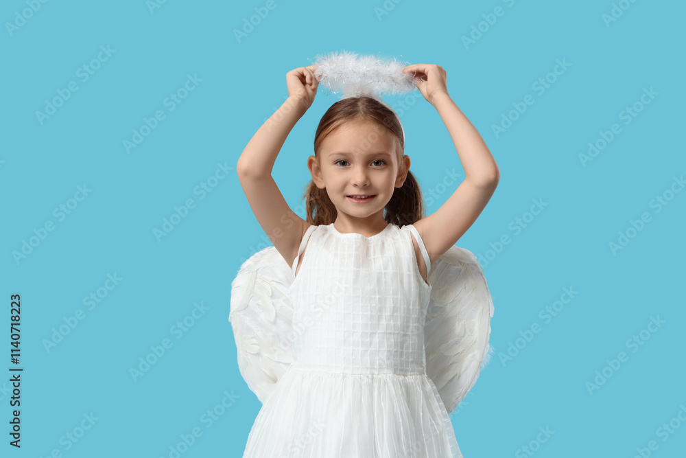 Cute little girl dressed as Cupid on blue background. Valentine's Day celebration Cute little girl dressed as Cupid on blue background. Valentine's Day celebration