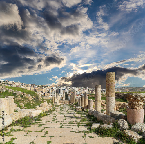 Roman ruins (against the background of a beautiful sky with clouds) in the Jordanian city of Jerash (Gerasa of Antiquity), capital and largest city of Jerash Governorate, Jordan #1140722414