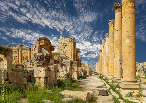 Roman ruins (against the background of a beautiful sky with clouds) in the Jordanian city of Jerash (Gerasa of Antiquity), capital and largest city of Jerash Governorate, Jordan #1140724220