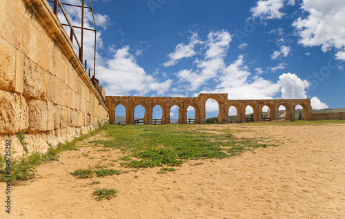 Roman ruins (against the background of a beautiful sky with clouds) in the Jordanian city of Jerash (Gerasa of Antiquity), capital and largest city of Jerash Governorate, Jordan #1140725292