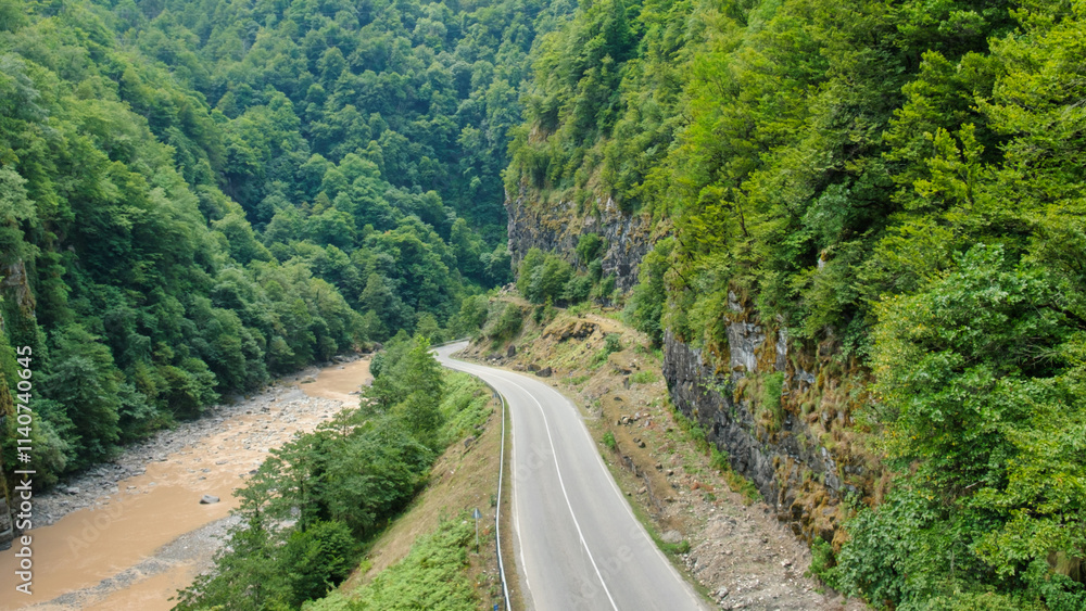 Mountain road through the forest landscape Mountain road through the forest landscape